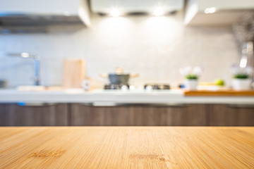 Wooden table top on blur kitchen room background. For displaying the assembly product or visual arrangement of the configuration keys