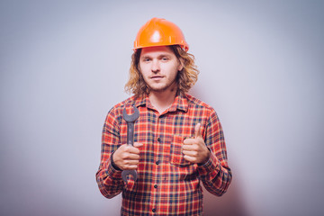 Portrait of young handyman holding a wrench