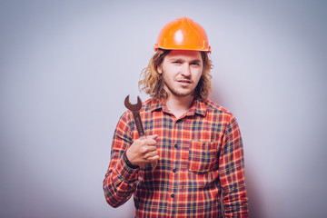 Portrait of young handyman holding a wrench