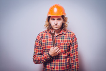 Portrait of young handyman holding a wrench