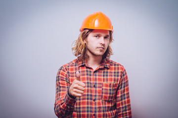 a man with a helmet shows OK