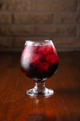 Cocktail in ice bar on blurred wooden background