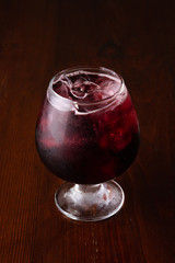 Cocktail in ice bar on blurred wooden background