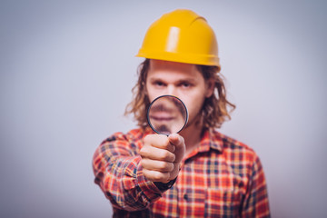 builder with magnifying glass