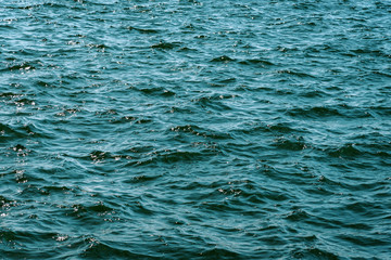Surface of deep blue ocean water with small waves in close-up (high details).