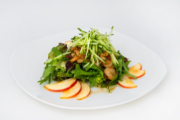 Salad of king prawns, sorrel, lettuce, cucumbers, lemon balm. The salad is seasoned with olive oil and lemon juice. Garnished with thinly sliced apple