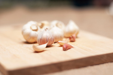 Fresh garlic on wooden cutting board.