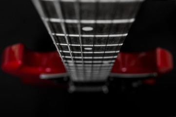 Red electric guitar closeup  on black background