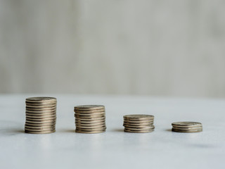 Descending coin columns form a downward line with copy space