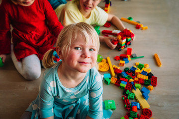 Fototapeta na wymiar kids playing with plastic blocks at home, indoor games