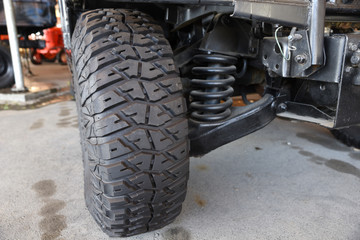 Close-up new military jeep tire and car suspension of an vintage jeep © milotus