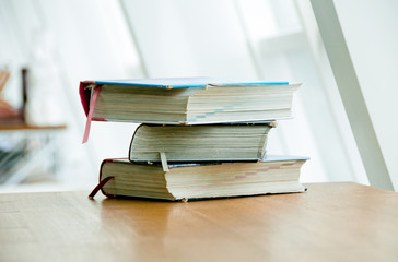 Books on the table. No labels, space for text. Pile of books on a wooden table. World literacy day. Concept of education or back to school.  Free space.