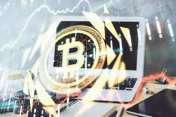 Crypto currency theme hologram with businessman working on computer on background. Concept of...