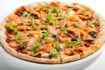 Sliced pizza with salmon, calamata olives and sun dried tomatoes