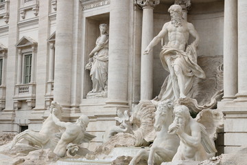 Trevi Fountain with baroque sculptures in travertine marble.