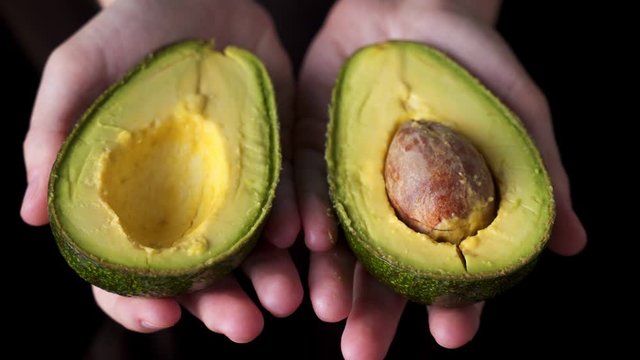 Close up hand open avocado fruit