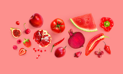 Creative layout made of red apple, red pepper, red grape, beetroot, watermelon, pomegranate, strawberry, raspberry, cherry, chilli, tomato  on the red background. Flat lay. Macro  concept.