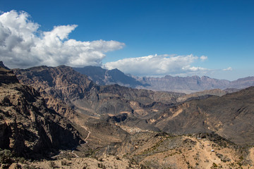 Mountain and valley view along Wadi Sahtan road in Al Hajir mountains between Nizwa and Mascat in Oman