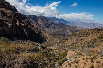 Mountain and valley view along Wadi Sahtan road in Al Hajir mountains between Nizwa and Mascat in Oman