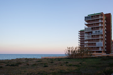 buildings on the Mediterranean beachfront at sunset