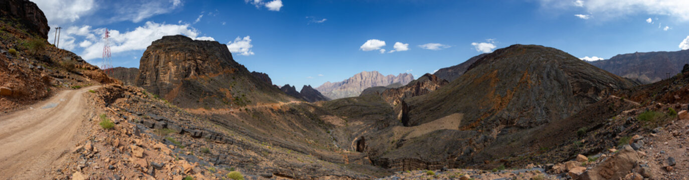 Mountain and valley view along Wadi Sahtan road and snake canyon in Al Hajir mountains between Nizwa and Mascat in Oman