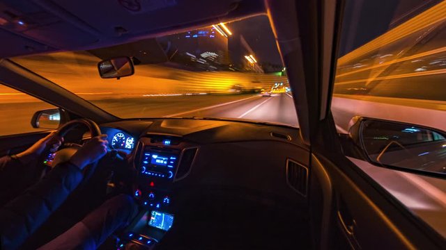 Timelapse video View from Side of Car moving in a night city, Blured road with lights with car on high speed. Concept rapid rhythm of a modern city.