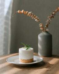 New York cheesecake or classic cheesecake with fresh berries on white plate, wooden table background and copy space for text