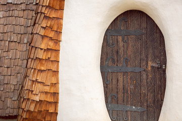 Old wooden weathered castle door with wrought iron