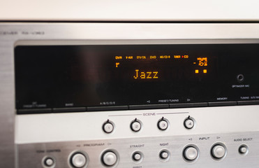 music buttons on control panel with display of an amplifier