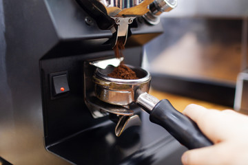 Grounded coffee is being prepared in coffee machine  - obrazy, fototapety, plakaty