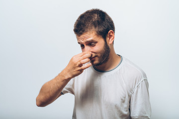 The stench. Closes the man's nose