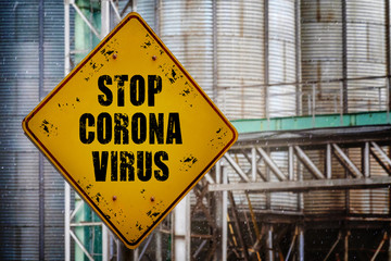 Stop coronavirus text on yellow grunge sign on industrial background.Covid-19 quarantine. Coronavirus infection warning sign. Stop Coronovirus design concept.