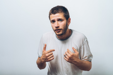 Male hand forefinger pointing to himself on the chest. Gesture. who am i. On a gray background