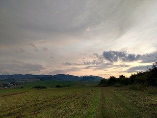 Fototapeta premium Sunrise or sunset over the hills and meadow. Slovakia