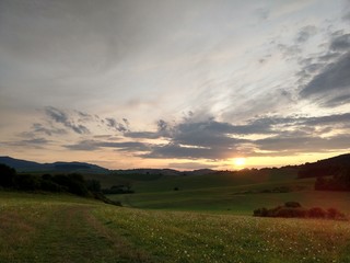 Fototapeta premium Sunrise or sunset over the hills and meadow. Slovakia