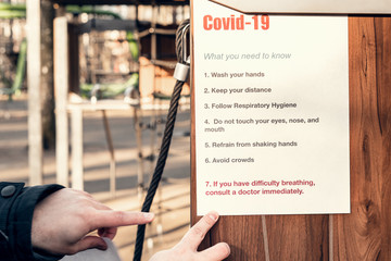 Note covid-19, what you need to know. Hanging on on an empty playground in a park. Self-isolation and quarantine in a pandemic.