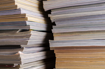 Closeup background of a pile of magazines.