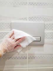 Disinfection of the toilet flush button in public places, preventing the spread of coronavirus.