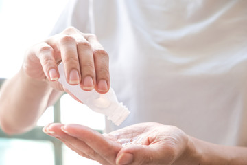 Asian women cleaning hand by alcohol gel to prevent spread of germs, bacteria and virus