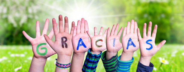 Many Children Hands Building Colorful Spanish Word Gracias Means Thank You. Sunny Green Grass...