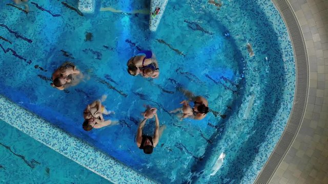 Mothers with kids in the pool
