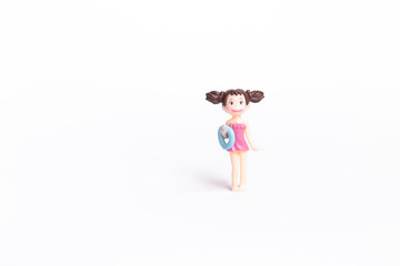 Cute little girl doll in pink swimsuite isolate on white background, summer fashion