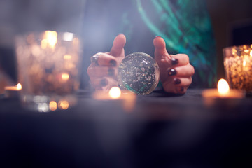 Close-up of fortuneteller woman's hands with predictions ball