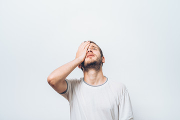  man covers his face by hand