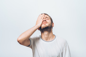  man covers his face by hand