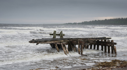 An old, ruined pier in inclement weather. Kola Peninsula, White sea.