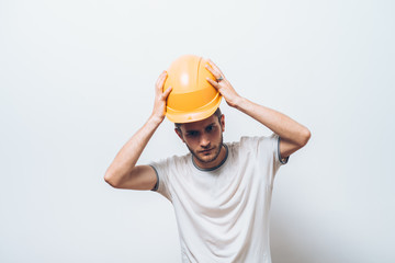 man close-up in helmet , holding his head by hand