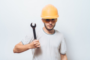 Portrait of young handyman holding a wrench