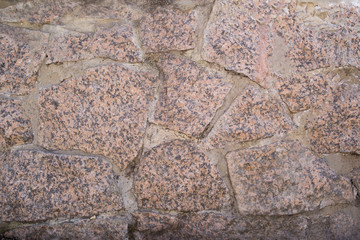 The texture of the walls made of granite stone. Part of the structure.