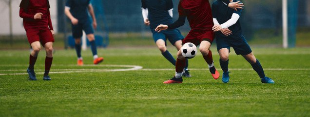 Horizontal picture of soccer match. Soccer football players competing for ball and kick ball during...